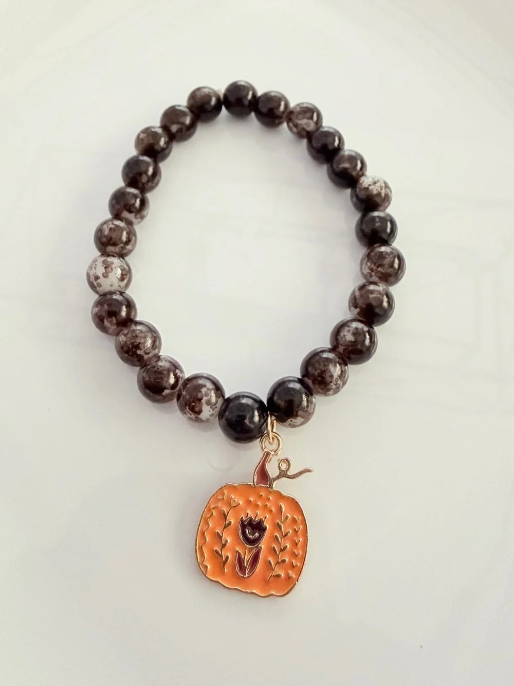 Brown Beaded Bracelet with Orange Pumpkin Charm